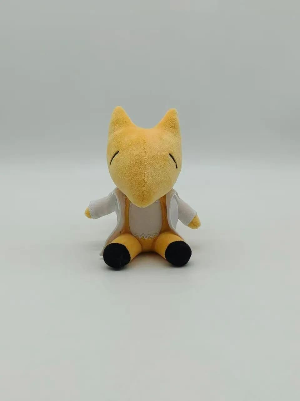 Yellow fox plush toy with a cream belly and embroidered eyes