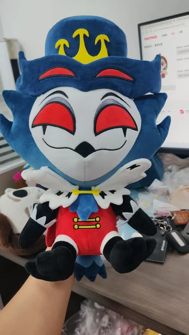 Blue character mascot plush with an appliqué face and a printed collar